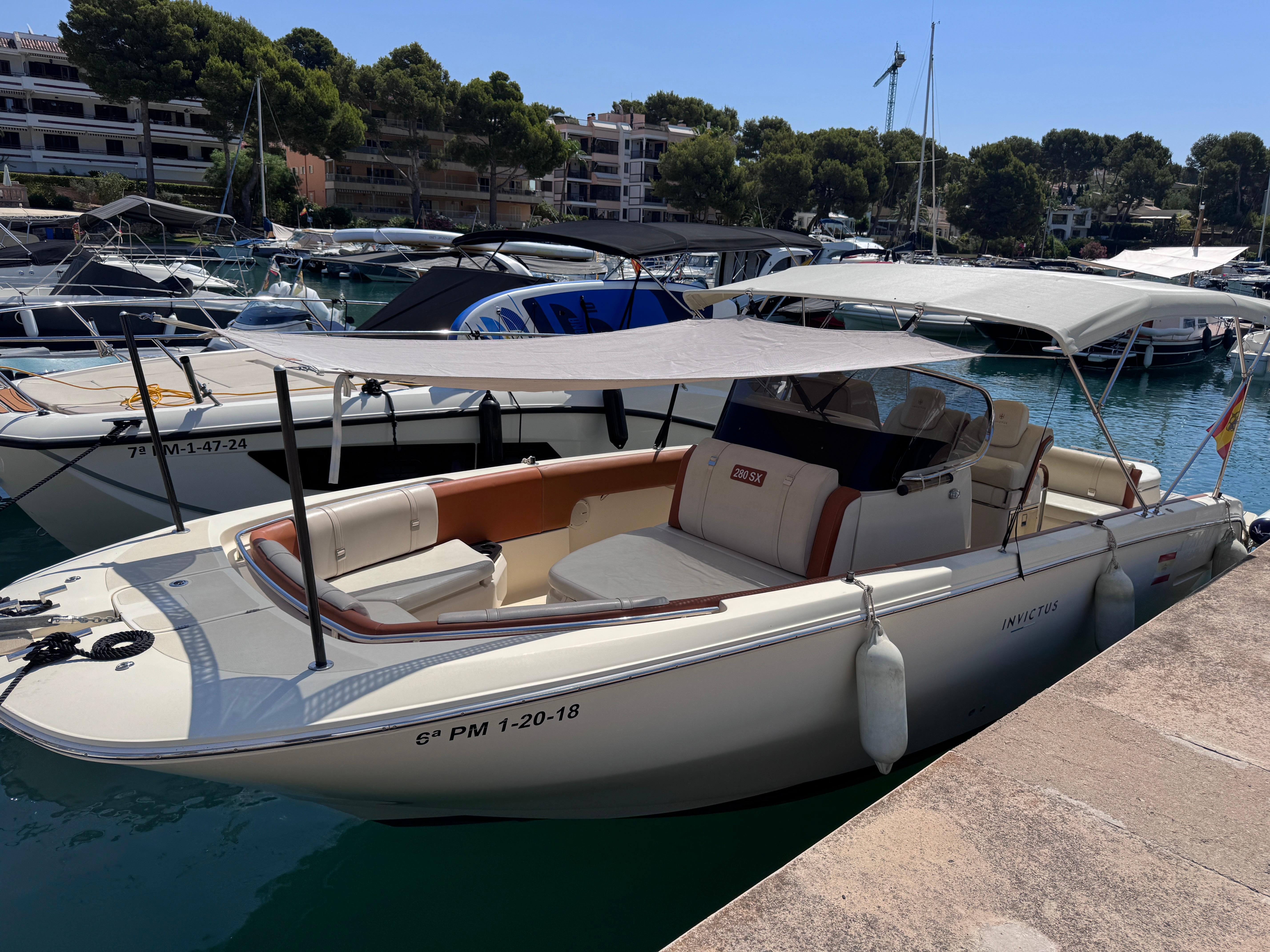 Invictus 280 SX Invictus 280 SX 2018 boat docked in a marina, featuring a sleek design and canopy.