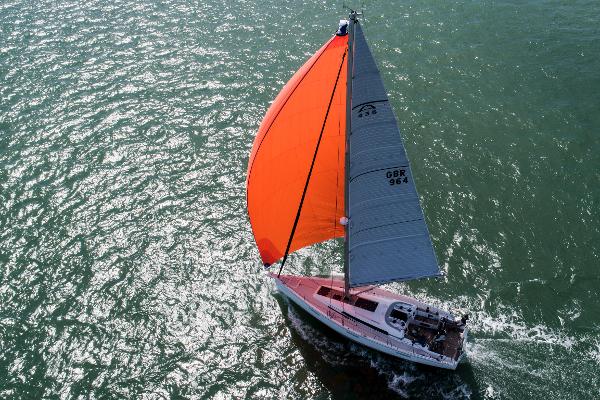 Arcona 435 Sailing yacht Arcona 435 (2022) with vibrant orange sail on open water.