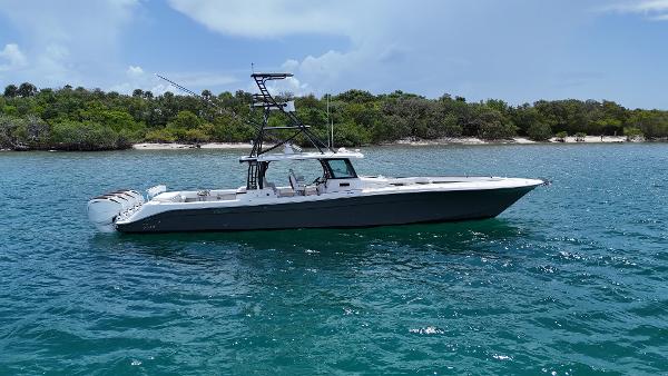 HCB 53 Sueños 2019 HCB 53 Sueños boat on clear blue water near a lush shoreline.