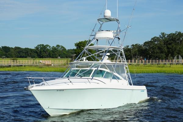 Contender 38 Express 2009 Contender 38 Express boat cruising on a scenic waterway.