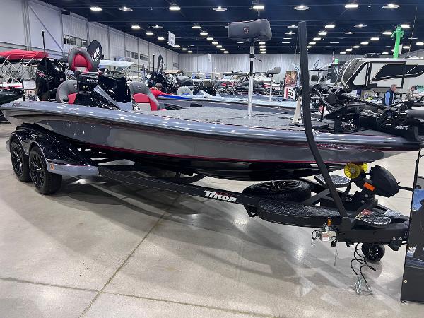 Triton 21XP Patriot 2025 Triton 21XP Patriot boat displayed indoors on a trailer.