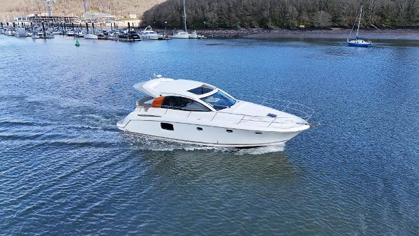Jeanneau Prestige 38S 2010 Jeanneau Prestige 38S yacht cruising on a calm river.