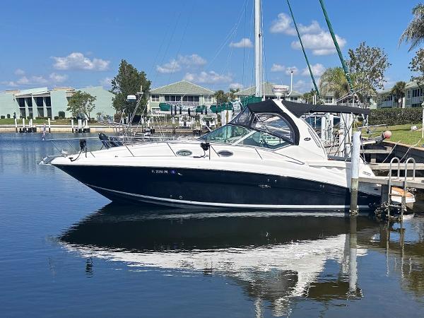 Sea Ray 320 Sundancer 2007 Sea Ray 320 Sundancer docked in a serene marina setting.