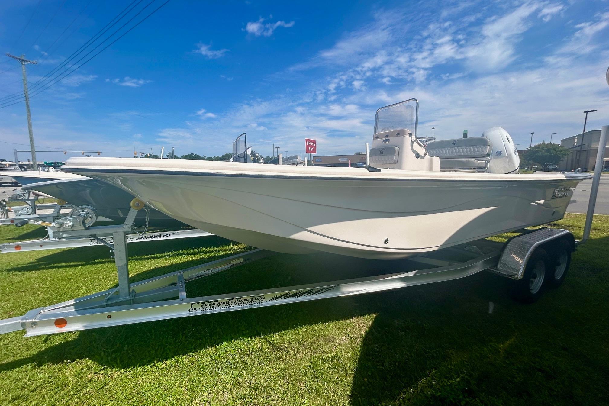 Carolina Skiff 21 LS 2025 Carolina Skiff 21 LS boat on trailer under clear blue sky.