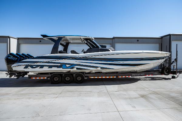 MTI V42 2023 MTI V42 boat on a trailer in front of a warehouse.