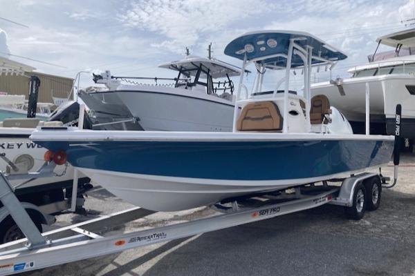 Sea Pro 250 DLX 2025 Sea Pro 250 DLX boat on trailer, blue hull, parked in marina.