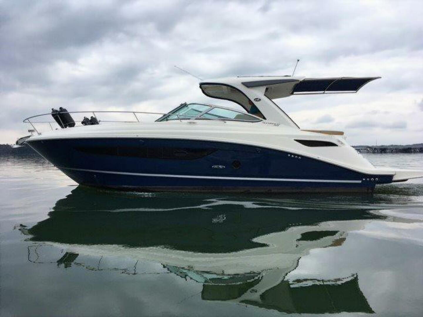 Sea Ray 350 Sundancer 2016 Sea Ray 350 Sundancer yacht on calm water under cloudy sky.