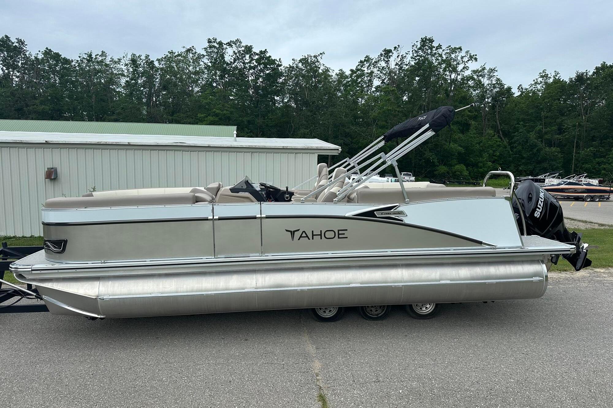 Tahoe 2385 2025 Tahoe 2385 pontoon boat parked outdoors, featuring sleek design and modern amenities.