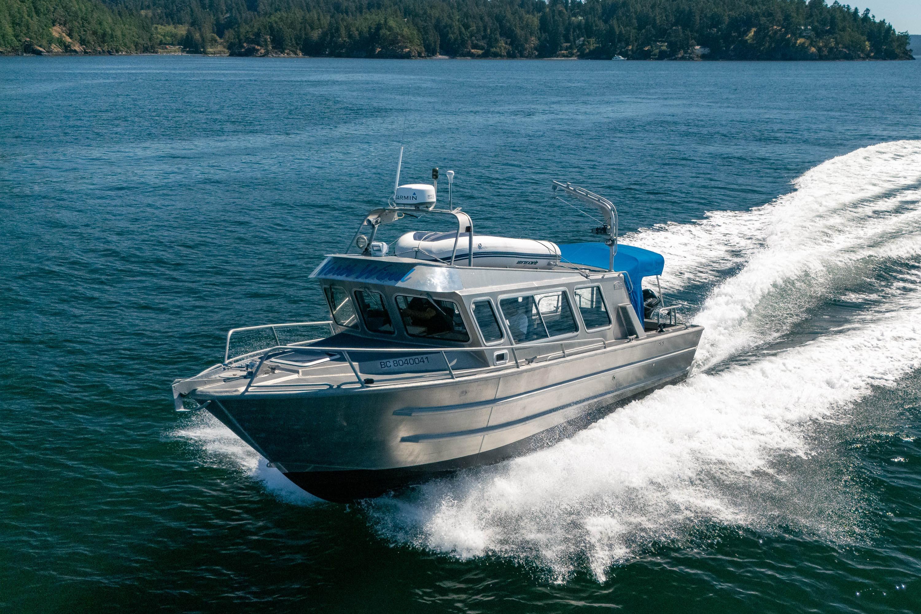 EagleCraft 31 Cruiser EagleCraft 31 Cruiser 2004 navigating scenic waters with forested shoreline.