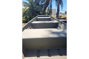 Tracker Grizzly 12 Jon 2026 Tracker Grizzly 12 Jon boat interior with bench seats, surrounded by palm trees.