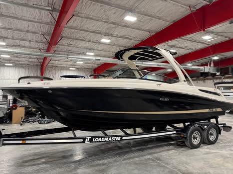 Sea Ray 250 SLX 2015 Sea Ray 250 SLX boat on Loadmaster trailer in indoor storage facility.