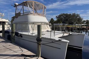 PDQ 34 Power Catamaran 2005 PDQ 34 Power Catamaran docked, featuring a covered flybridge and sleek design.