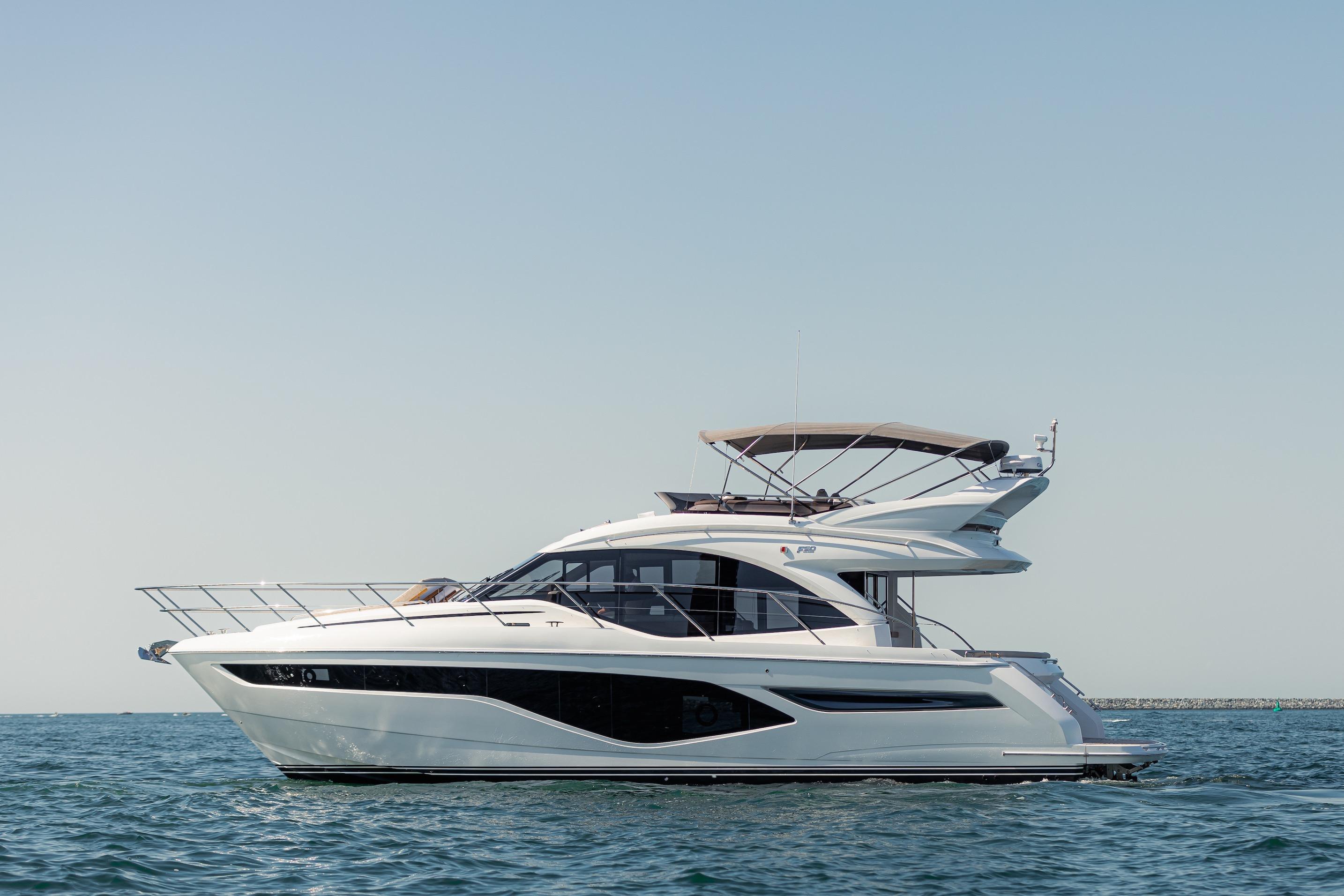 Princess F50 2023 Princess F50 yacht cruising on calm blue waters under clear sky.