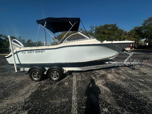 Key West 239 DFS 2022 Key West 239 DFS boat on trailer, parked outdoors under clear blue sky.