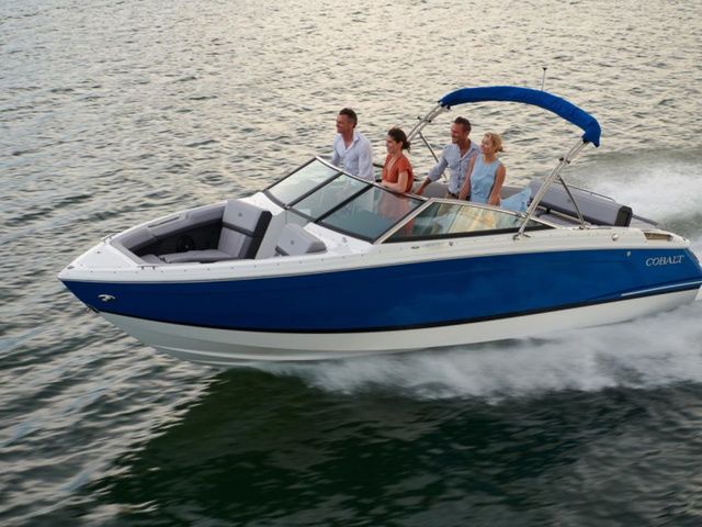 Cobalt R4 2023 Cobalt R4 boat cruising on water with four passengers onboard.