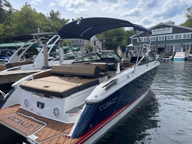 Cobalt R4 2023 Cobalt R4 boat docked at marina, featuring sleek design and spacious seating.