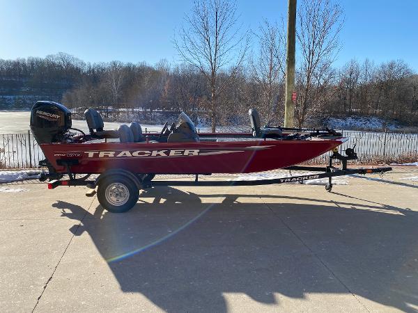 Tracker Pro 170 2025 Tracker Pro 170 boat on trailer, parked outdoors on a sunny day.