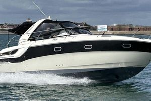 Bavaria Sport 31 2012 Bavaria Sport 31 motorboat cruising on water, with a "For Sale" sign visible.