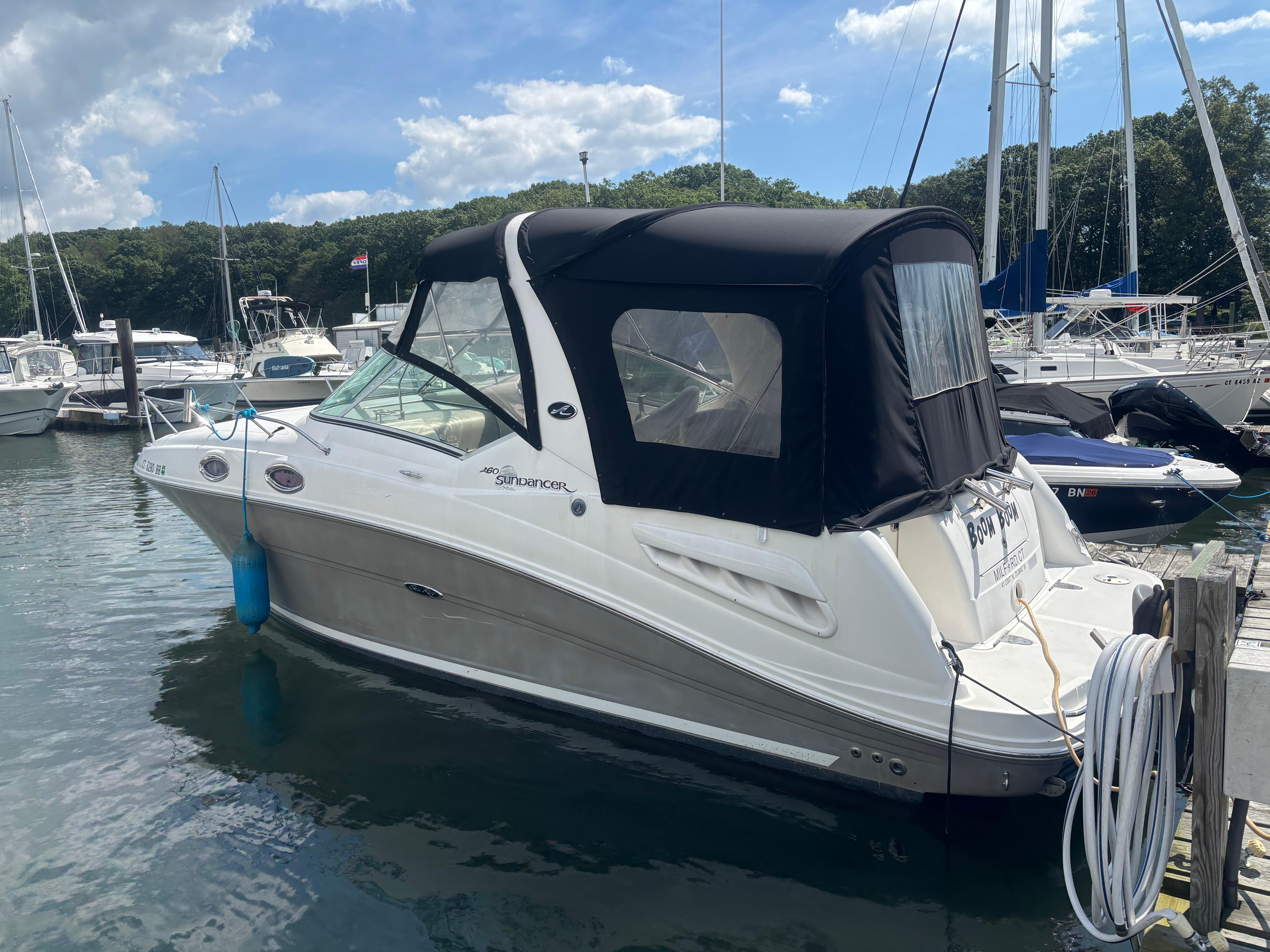 Sea Ray 260 Sundancer 2006 Sea Ray 260 Sundancer boat docked at marina under blue sky.