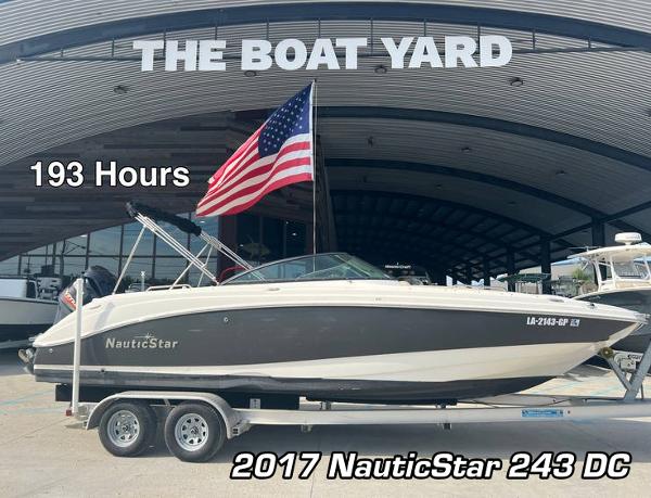 NauticStar 243 DC 2017 NauticStar 243 DC boat on trailer at The Boat Yard, 193 hours, American flag displayed.