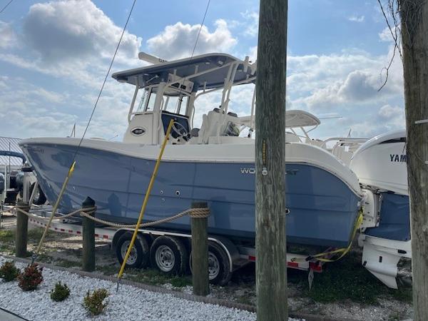 World Cat 295 CC 2022 World Cat 295 CC boat on trailer, parked outdoors under cloudy sky.