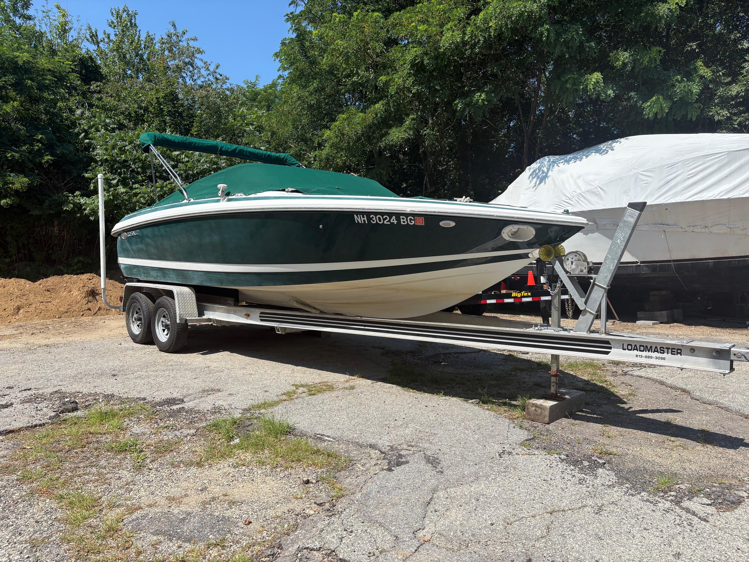 Cobalt 226 2001 Cobalt 226 boat on trailer, green canopy, parked outdoors.