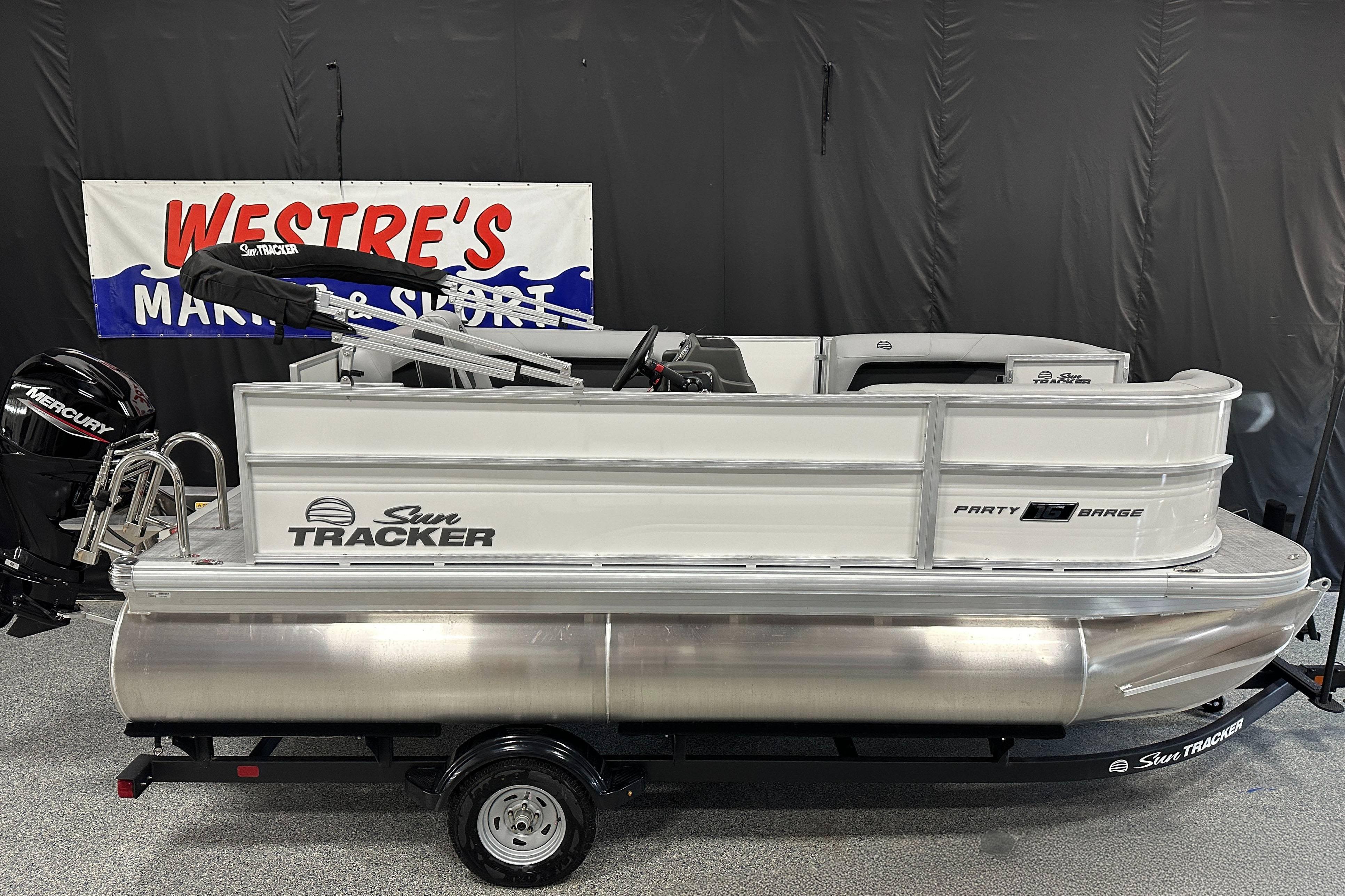Sun Tracker Party Barge 16 DLX 2026 Sun Tracker Party Barge 16 DLX pontoon boat displayed indoors.