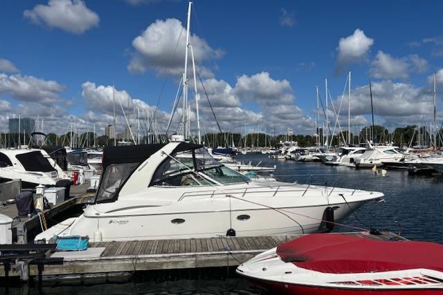 Cruisers Yachts 370 Express 2004 Cruisers Yachts 370 Express docked at a marina under a blue sky.