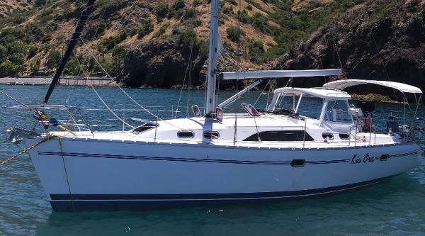 Catalina 385 2014 Catalina 385 sailboat anchored in scenic bay with rocky hills.