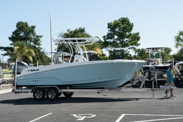 Wellcraft 242 Fisherman 2023 Wellcraft 242 Fisherman boat on a trailer in a parking lot.