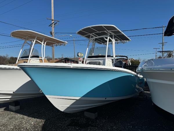 NauticStar 212 Legacy 2025 NauticStar 212 Legacy boat with blue hull and T-top, displayed outdoors.