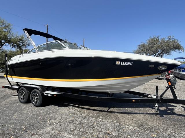 Cobalt 242 2008 Cobalt 242 boat on a trailer, black and white exterior with yellow stripe.