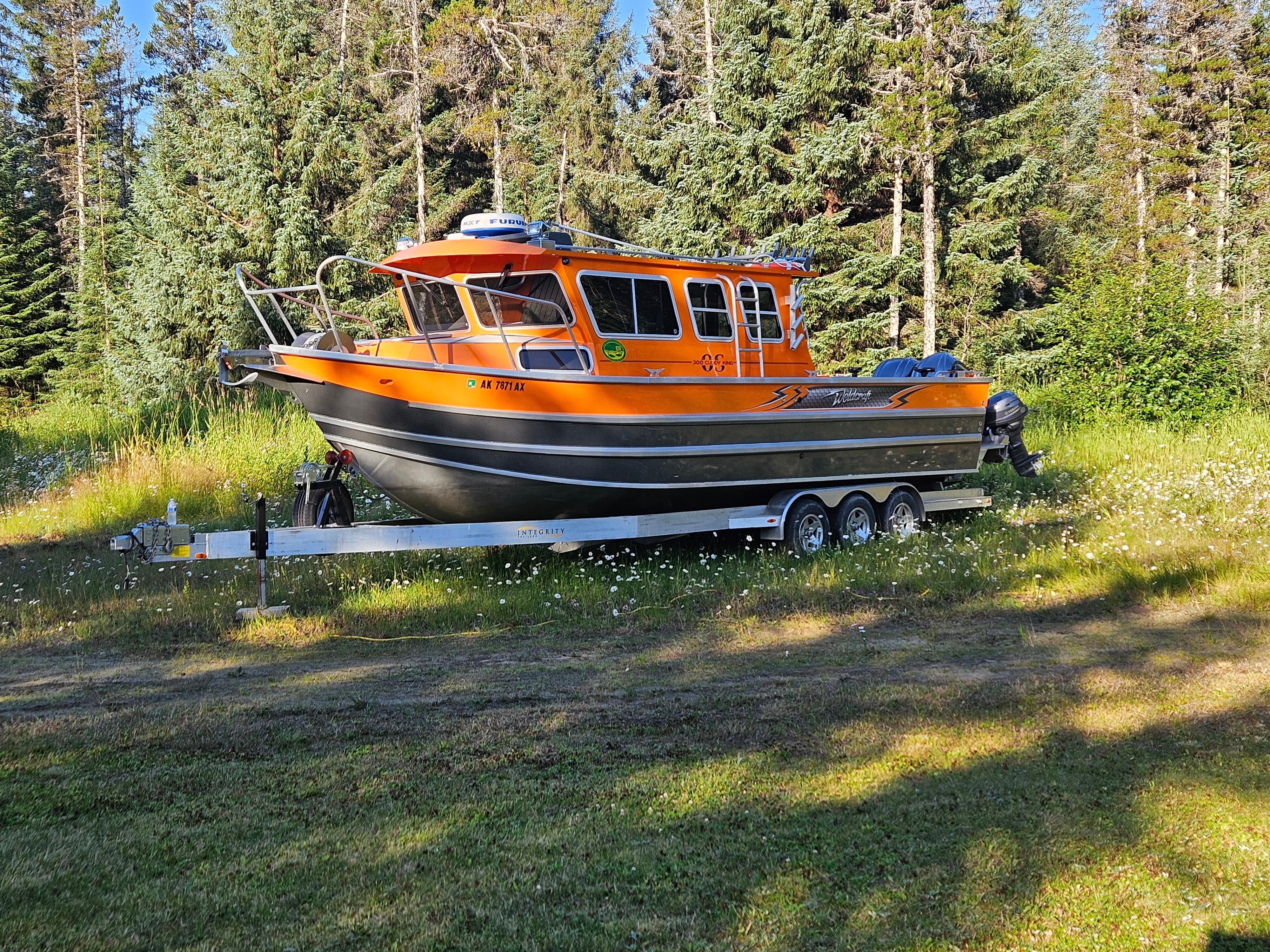 Weldcraft 300 OS 2022 Weldcraft 300 OS boat on trailer in a grassy area with trees.