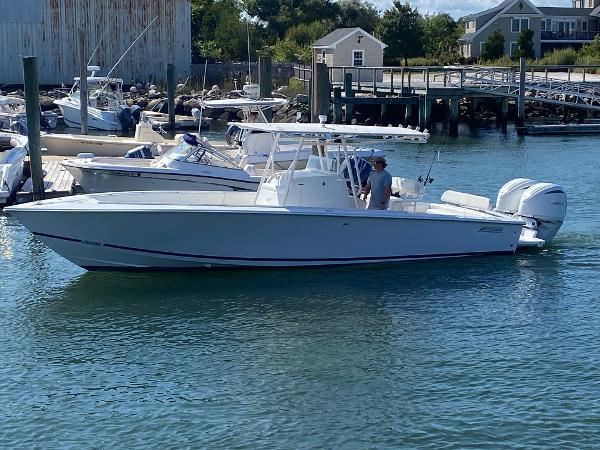 Jupiter 31 Fs 2004 Jupiter 31 FS boat docked in a marina with scenic waterfront background.