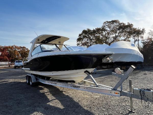 Scout 277 Dorado 2022 Scout 277 Dorado boat on trailer, parked outdoors under clear sky.