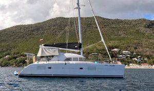 Lagoon 380 S2 2016 Lagoon 380 S2 catamaran sailing near a lush, hilly coastline.