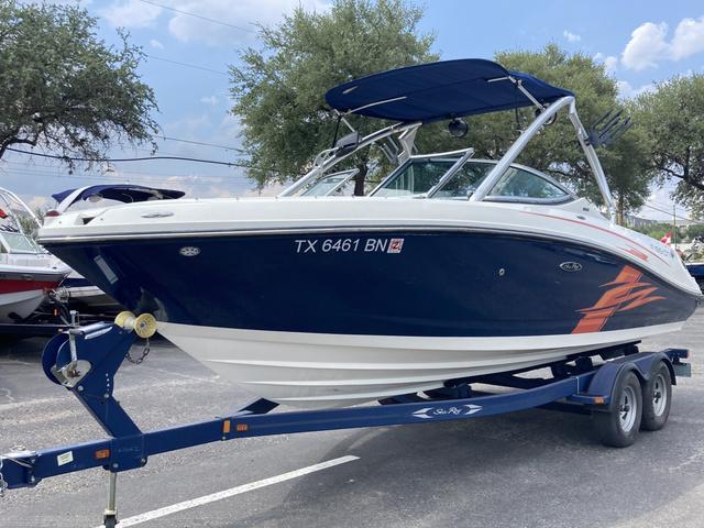 Sea Ray 230 SLX 2011 Sea Ray 230 SLX boat on a trailer with blue and white hull.