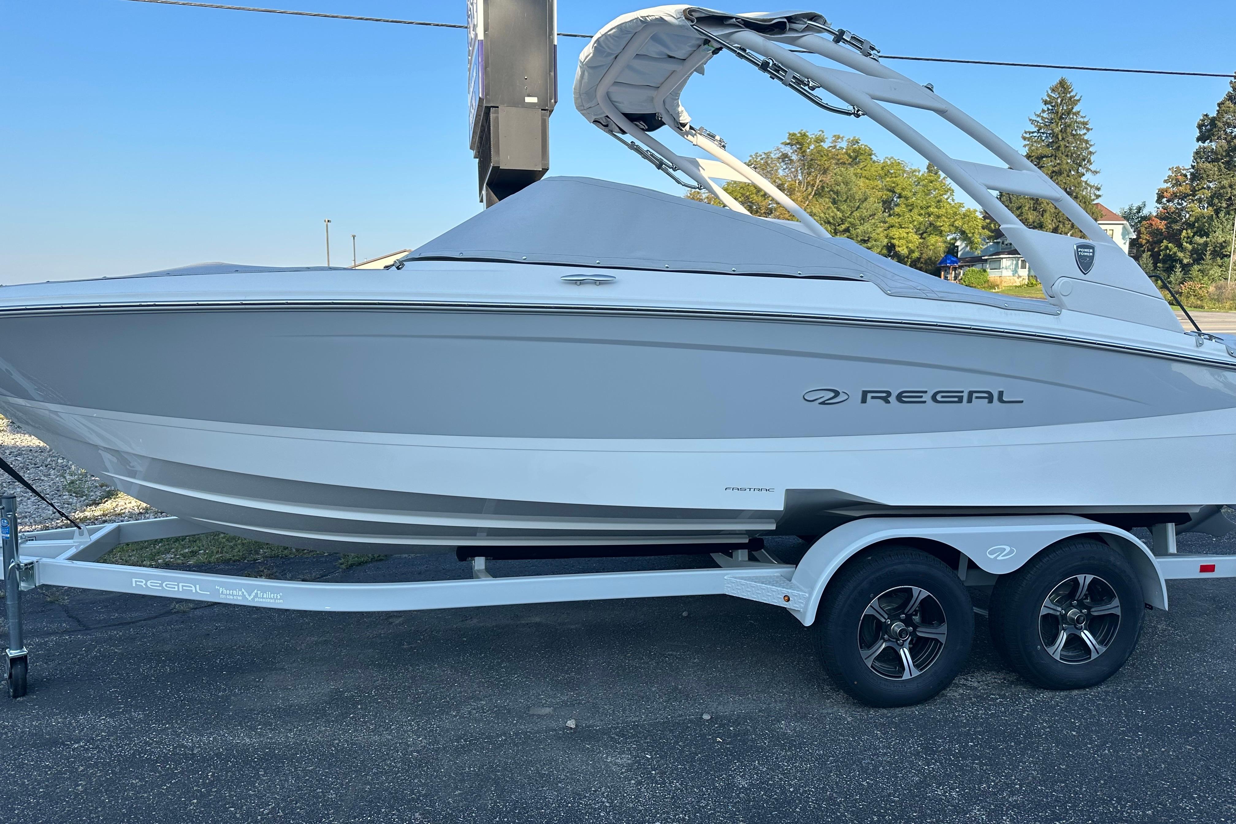 Regal LS2 2026 Regal LS2 boat on trailer, sleek design, parked outdoors.