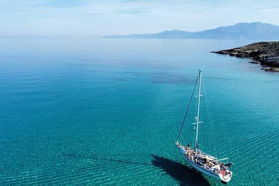 Custom Conyplex CONTEST 46 Sailboat "Contest 46" (1988) on clear turquoise sea near rocky coastline.