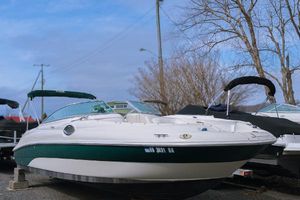 Sea Ray 240 Sundeck 2003 Sea Ray 240 Sundeck boat on display, featuring a sleek design and green accents.