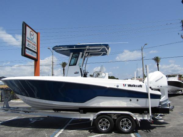 Wellcraft 243 Fisherman 2024 Wellcraft 243 Fisherman boat on a trailer in a parking lot.