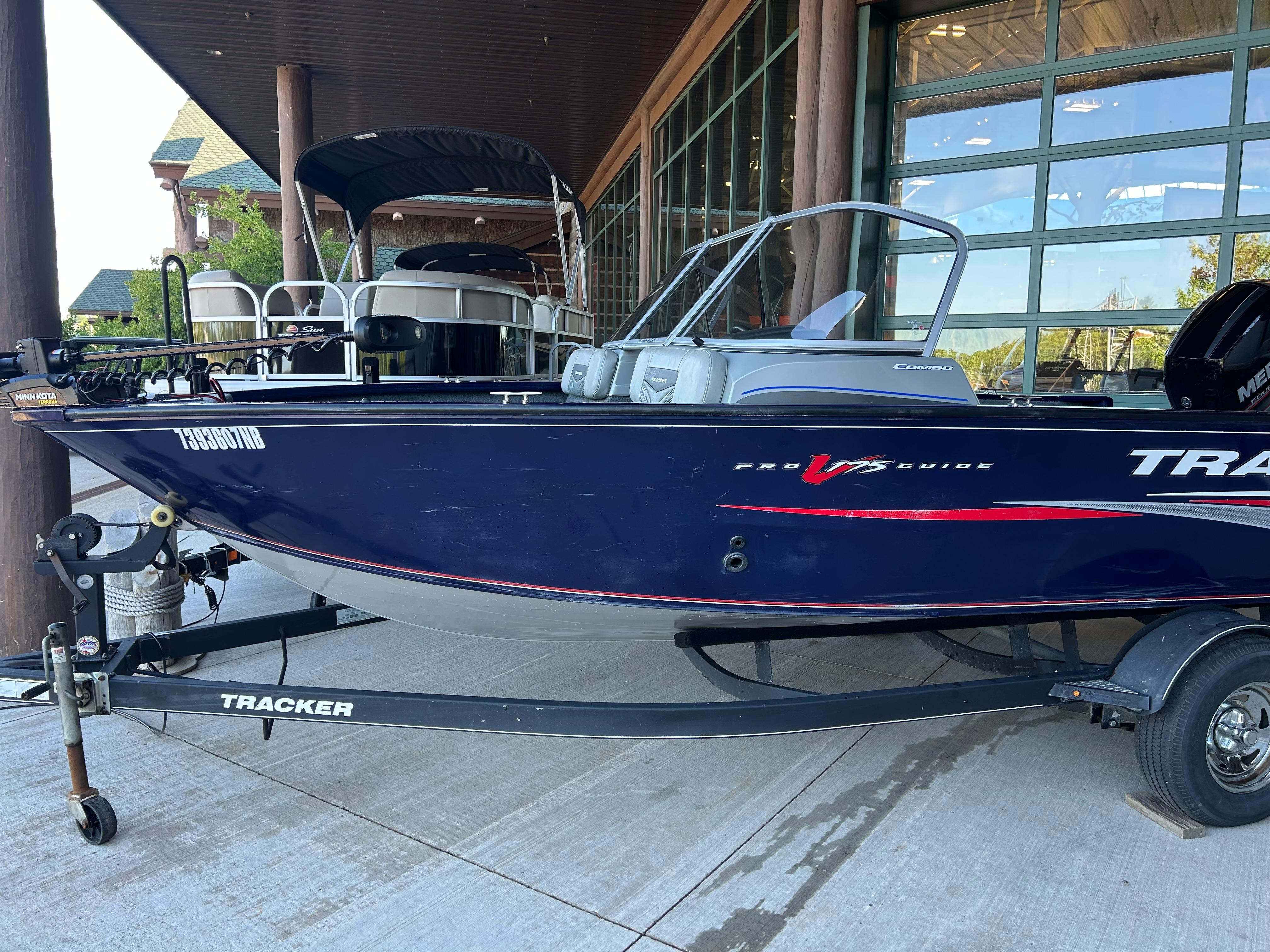 Tracker Pro Guide V-175 Combo 2019 Tracker Pro Guide V-175 Combo boat on trailer, parked outside a building.