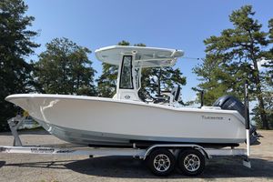 Tidewater 220 LXF 2026 Tidewater 220 LXF boat on trailer, surrounded by trees under clear sky.