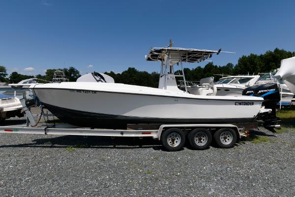 Contender 25 Tournament 1994 Contender 25 Tournament boat on trailer, parked outdoors.