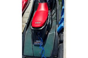 Yamaha WaveRunner EX Sport 2024 Yamaha WaveRunner EX Sport with red seat, docked and ready for adventure.