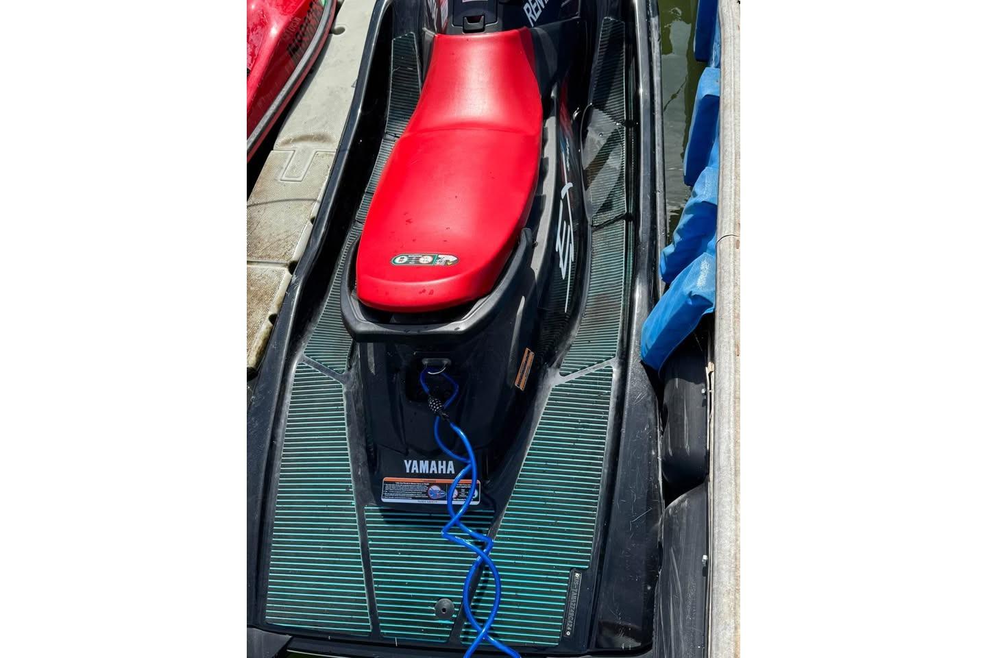 Yamaha WaveRunner EX Sport 2024 Yamaha WaveRunner EX Sport with red seat, docked and ready for adventure.