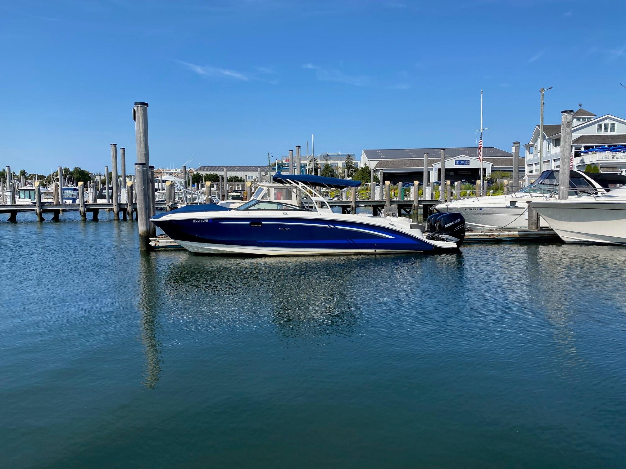 Sea Ray SDX 290 Outboard 2017 Sea Ray SDX 290 Outboard boat docked at a marina under clear blue skies.