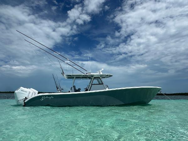 Yellowfin 39 2024 Yellowfin 39 boat in clear turquoise water under a partly cloudy sky.