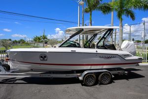 Monterey Elite 27 OB 2026 Monterey Elite 27 OB boat on trailer, parked under clear blue sky.
