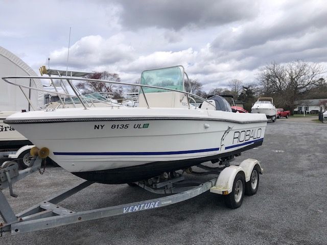 Robalo 1820 1995 Robalo 1820 boat on trailer, parked outdoors under cloudy sky.